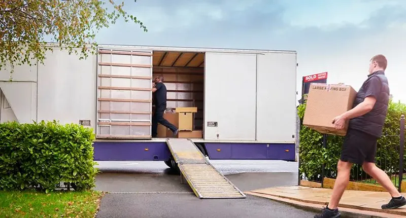 Palmer Moving employees loading boxes with belongings to the truck